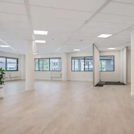 Spacious office space with large windows and light flooring at Asch van Wijckstraat. Perfect for rent office activities in Amersfoort Centrum.