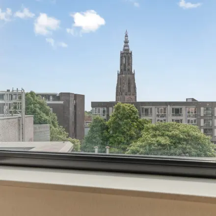 View from a window at an office space rental in Amersfoort Centrum, showcasing cityscape and greenery.