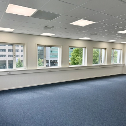 Bright office space for rent at Professor E.M. Meijerslaan 1, Amstelveen, featuring large windows and carpeted flooring, ideal for office space rental.