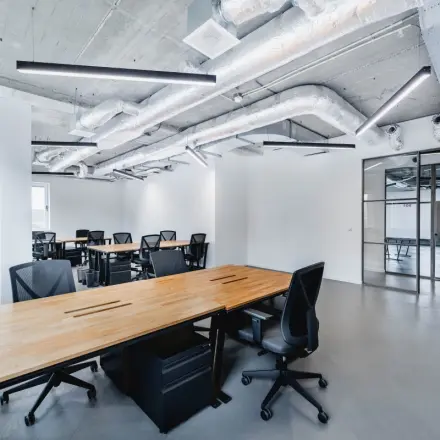 Spacious office space for rent at H.J.E. Wenckebachweg 90-108, showcasing modern interiors with industrial-style ceilings and sleek work desks, perfect for collaborative work in Amsterdam Amstel Business Park.