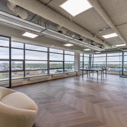 Spacious office space with large windows in Amsterdam Amstel Business Park, available for rent. The room offers natural light and scenic views, ideal for office space rental.