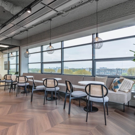 Chic office space featuring stylish seating and large windows at Joop Geesinkweg 201 in Amsterdam Amstel Business Park. Ideal for companies seeking office space rental opportunities.
