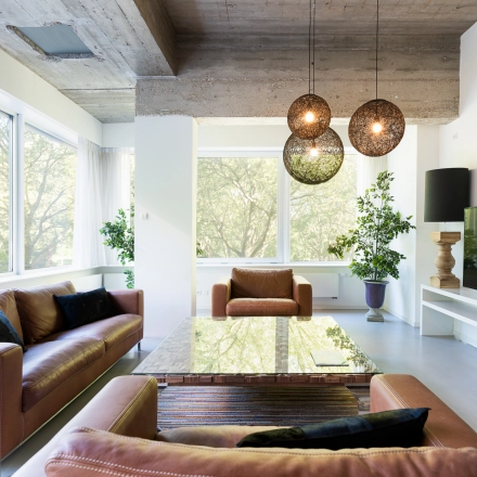 Spacious office lounge at Teilingen 1 in Amsterdam Buitenveldert, featuring leather seating, modern decor, and large windows overlooking greenery. Ideal for office space rental with a welcoming ambiance.