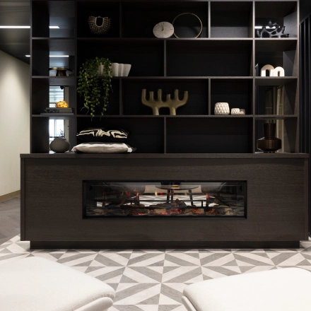 Stylish interior view of an office lounge at Walborg 2A, Amsterdam Buitenveldert, featuring modern decor with a decorative fireplace and shelving. Perfect for office space rental.