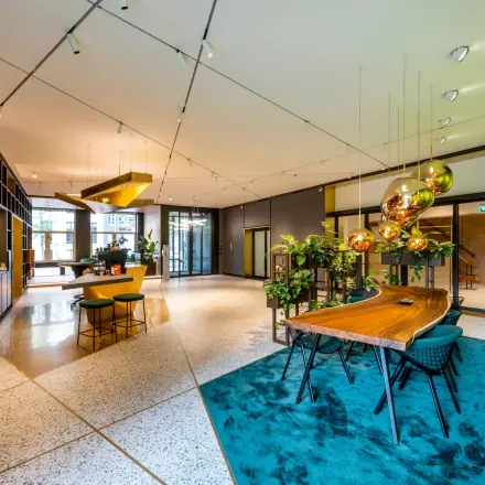 Modern office space at Herengracht 459-469 in the Amsterdam Canal Belt, featuring vibrant decor and ample natural light, perfect for office space rental.