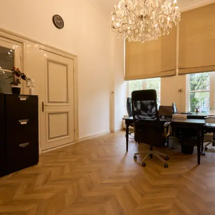 Office space with elegant wooden flooring, a chandelier, and large windows at Keizersgracht 391A in Amsterdam Canal Belt, perfect for those seeking office space rental.