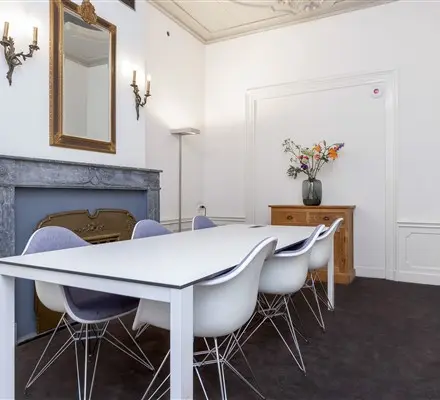 Furnished office to rent at Keizersgracht 62-64 in Amsterdam Canal Belt, featuring a sleek table and modern chairs, ideal for hosting meetings.