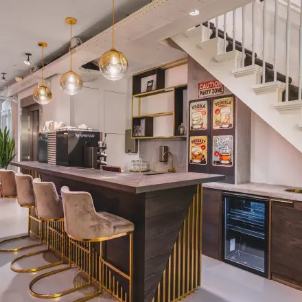 Stylish office space in Amsterdam Center featuring a modern bar area with seating and decorative lighting, ideal for rent office space.