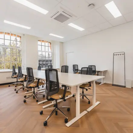 Bright and spacious office space rental at Herengracht 471, Amsterdam Center, featuring modern chairs and tables arranged for collaborative work.