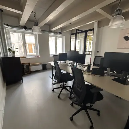 Bright office space at Kloveniersburgwal 131K, Amsterdam Center, featuring modern desks and chairs with computers, ideal for an office space rental.