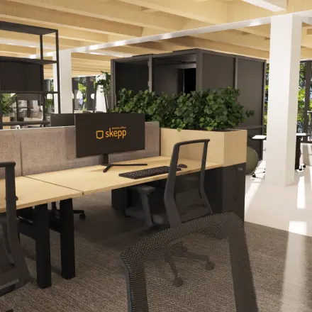 Modern office space in Amsterdam Center featuring open workstations with sleek chairs and monitors, ideal for office space rental. Natural light streams through large windows overlooking greenery.