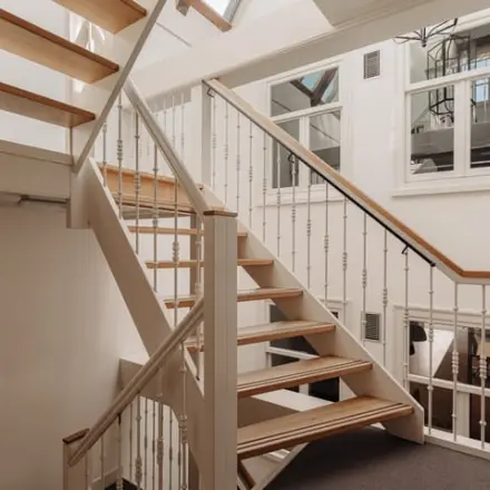 Interior view of a well-lit staircase at Prins Hendrikkade 14, Amsterdam Center, ideal for office space rental.