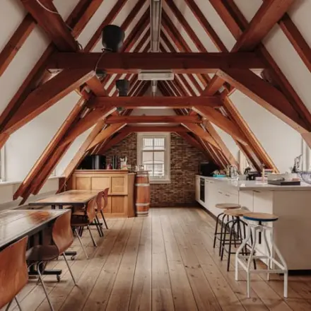 Charming office to rent with wooden beams and rustic furnishings at Prins Hendrikkade 14, Amsterdam Center, perfect for business activities.