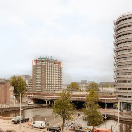Exterior view from Prins Hendrikkade 14 in Amsterdam Center with nearby buildings and canal visible.