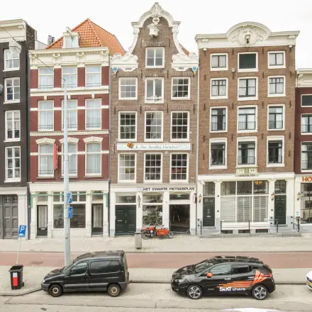 Street view of Prins Hendrikkade 14 in Amsterdam Center, showcasing historic buildings ideal for office space rental.