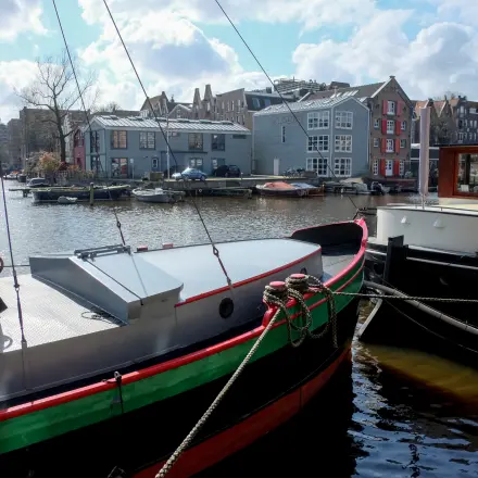 Exterior view of boats docked near Prinseneiland 23A in Amsterdam Center, with office spaces nearby, available for rent.
