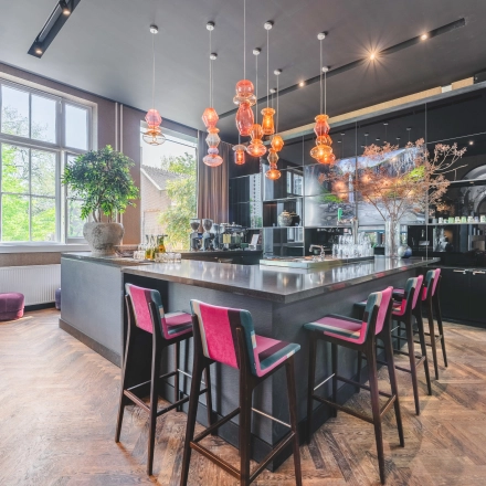 Modern furnished office space with a stylish bar area, located at Raamplein 1, Amsterdam Center, available for office space rental.