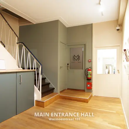 Entrance hall of an office space at Warmoesstraat 155, Amsterdam Center, with wooden floors and minimalistic design. Ideal for office space rental.