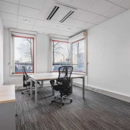 Furnished office space rental at Daalwijkdreef 47, Amsterdam Duivendrecht, featuring desks and chairs near large windows.
