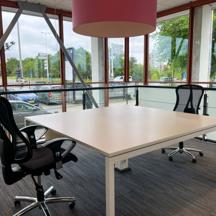 Bright office to rent in Amsterdam Duivendrecht, featuring large windows, two chairs, and a desk, ideal for office space rental.