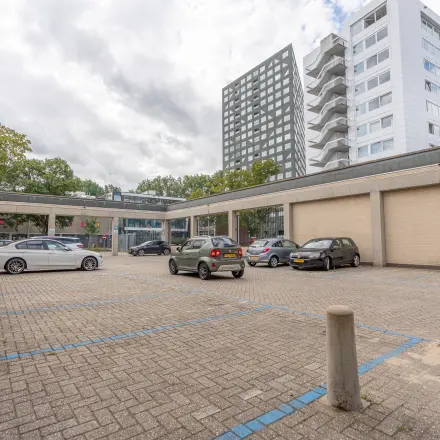 Parking area at James Wattstraat 71, Amsterdam East, with cars seen in designated spots, part of office space rental premises.