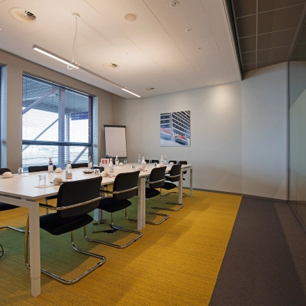 Modern conference room with long table and chairs at Piet Heinkade 55, Amsterdam East, ideal for office space rental.
