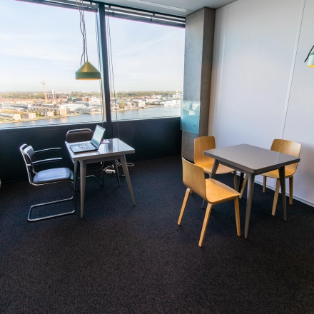 Bright office space for rent at Piet Heinkade 55, Amsterdam East, featuring modern furnishings and a stunning view, ideal for work and meetings.