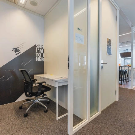 Office at Piet Heinkade 95B, Amsterdam East featuring a meeting cubicle and a coworking area. Ideal for those seeking office space rental. Spacious design with modern furnishings.