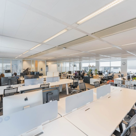 Spacious and well-lit office space in Amsterdam East with modern furnishings and workstations available for rent.
