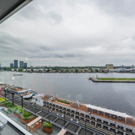 View of the waterfront and skyline from the office at Piet Heinkade 95B, ideal for those seeking office space rental in Amsterdam East.