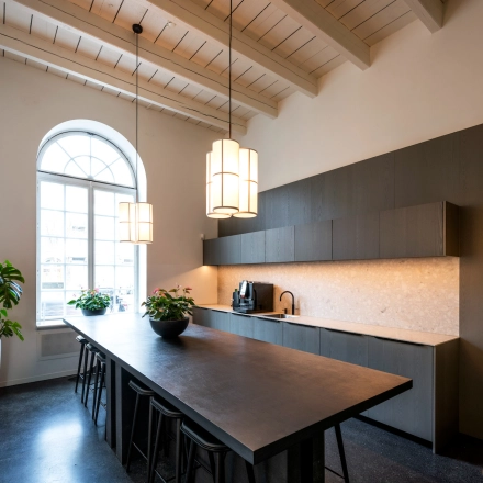 Elegant office space with a long table and chairs, located in Amsterdam East, perfect for meetings or workspace rental.