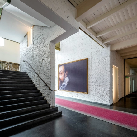View of the spacious office interior at Sarphatistraat 370, Amsterdam East, with a staircase and modern decor, ideal for office space rental.