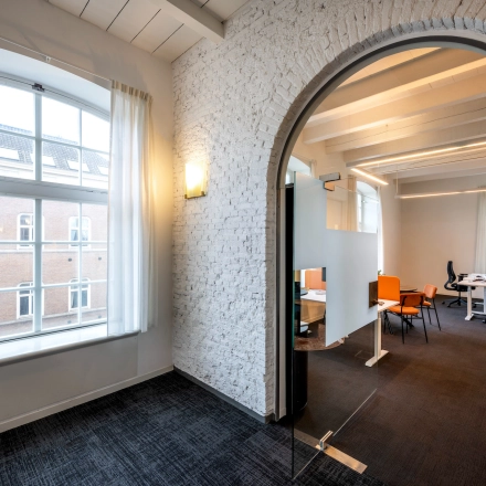 Bright office space for rent located at Sarphatistraat 370, Amsterdam East, featuring large windows and modern furnishings.