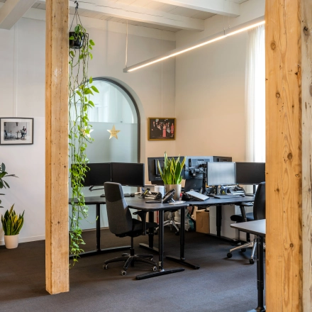Bright office space at Sarphatistraat 370, Amsterdam East, featuring modern furnishings and plants, available for office space rental.