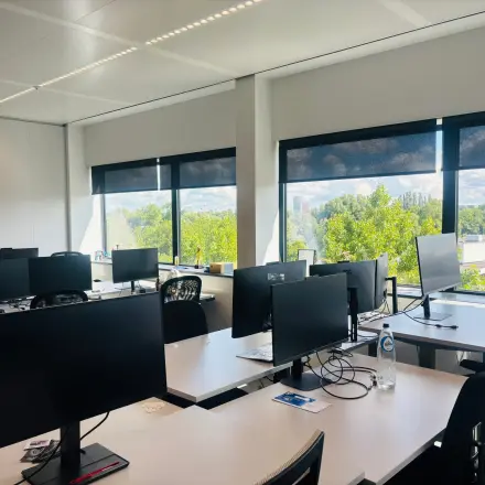 Bright, furnished office at Science Park 301 in Amsterdam East, featuring multiple desks with computer monitors and large windows providing natural light. Ideal for those seeking office space rental.