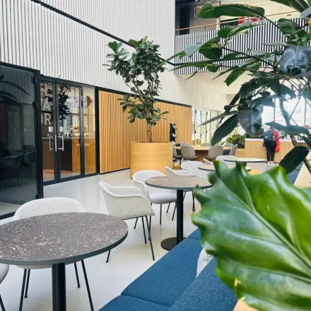 Modern office space at Science Park 301 in Amsterdam East, featuring stylish furniture, greenery, and a glass booth, ideal for rent office space or office space rental.