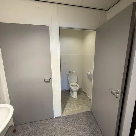 Interior view of a restroom with a toilet and sink, suitable as a part of office space rental at Buikslotermeerplein 430, Amsterdam North.