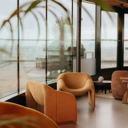 Furnished office space at Overhoeksplein 1, Amsterdam North with cozy seating and panoramic windows. Ideal for office space rental.