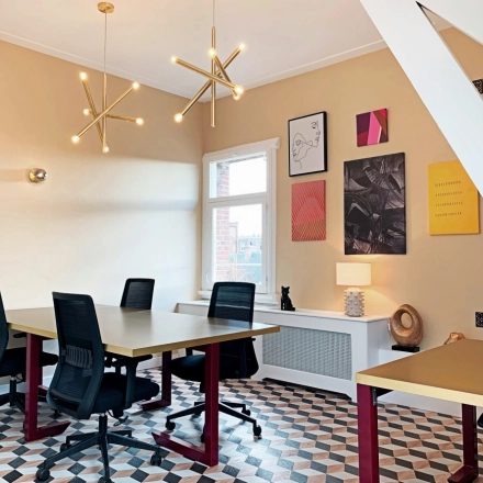Bright office space rental with modern lighting, geometric flooring, and contemporary art on the walls, available in Amsterdam Old South at Emmalaan 7-9.