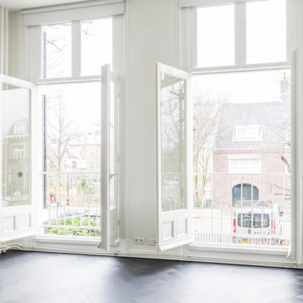 Bright office to rent at Sophialaan 21, Amsterdam Old South, featuring large windows with views of a charming street, perfect for office space rental opportunities.