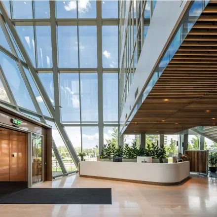 Spacious, bright office reception area with modern design and large windows at David Ricardostraat 1, ideal for office space rental in Amsterdam Riekerpolder.