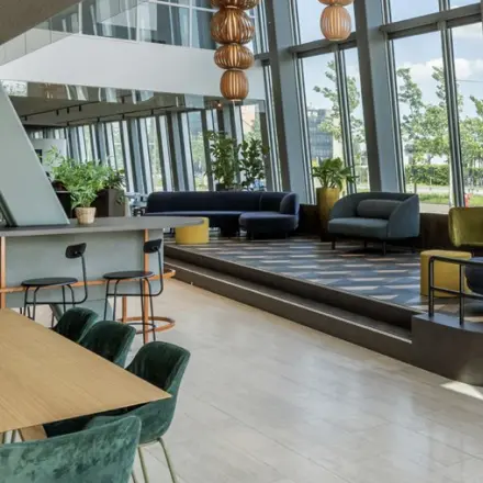 Spacious and modern office space with stylish furniture and large windows at David Ricardostraat 1, Amsterdam Riekerpolder, perfect for office space rental.