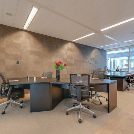 Modern office space rental in Amsterdam Riekerpolder with sleek furnishings, featuring stylish desks, ergonomic chairs, and bright lighting, creating a productive atmosphere. Convenient office to rent at Thomas R. Malthusstraat 1-3.