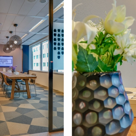 Stylish conference room in Amsterdam Riekerpolder at Thomas R. Malthusstraat 1-3, featuring a large table, chairs, modern lighting, and a decorative plant. Ideal office space rental.