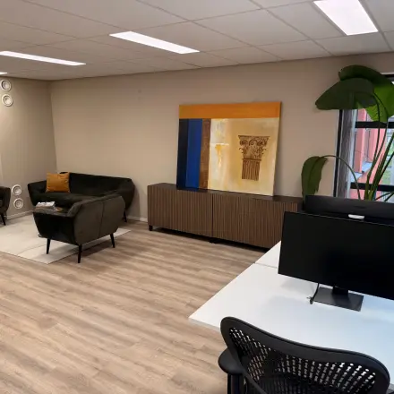 Furnished office space rental at Arlandaweg 92, Amsterdam Sloterdijk, featuring modern workstations, seating area, and decor.