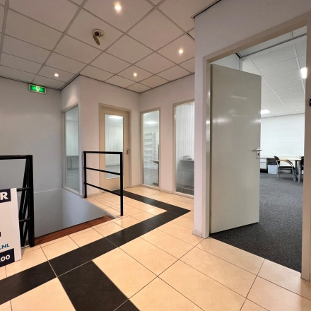 Interior view of office space available for rent at Contactweg 131 in Amsterdam Sloterdijk, featuring multiple open doors and tiled flooring.