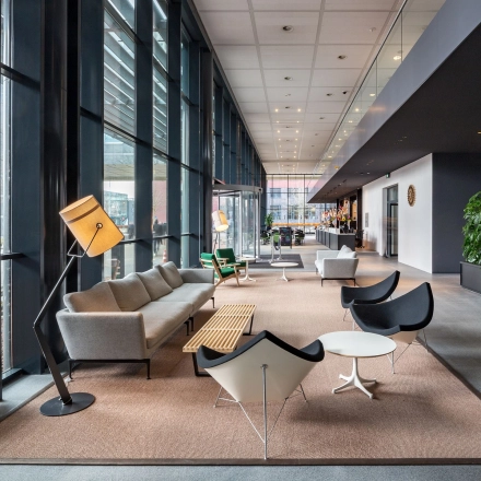 Modern office space with stylish furniture and large windows at Kingsfordweg 43, Amsterdam Sloterdijk, available for rent. Perfect for business professionals seeking a bright, open area for workspaces.