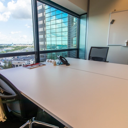 Furnished office space with a large window view at Radarweg 29, Amsterdam Sloterdijk, showcasing a table, chairs, and a whiteboard, perfect for rental.