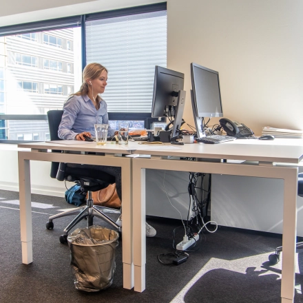 Modern office space for rent at Radarweg 29, Amsterdam Sloterdijk, featuring a professional setup with large windows and desks in use by professionals.