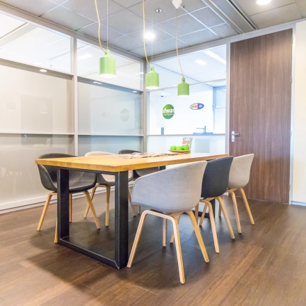 Bright office space with a wooden table and stylish chairs available for rent at Radarweg 29, Amsterdam Sloterdijk.